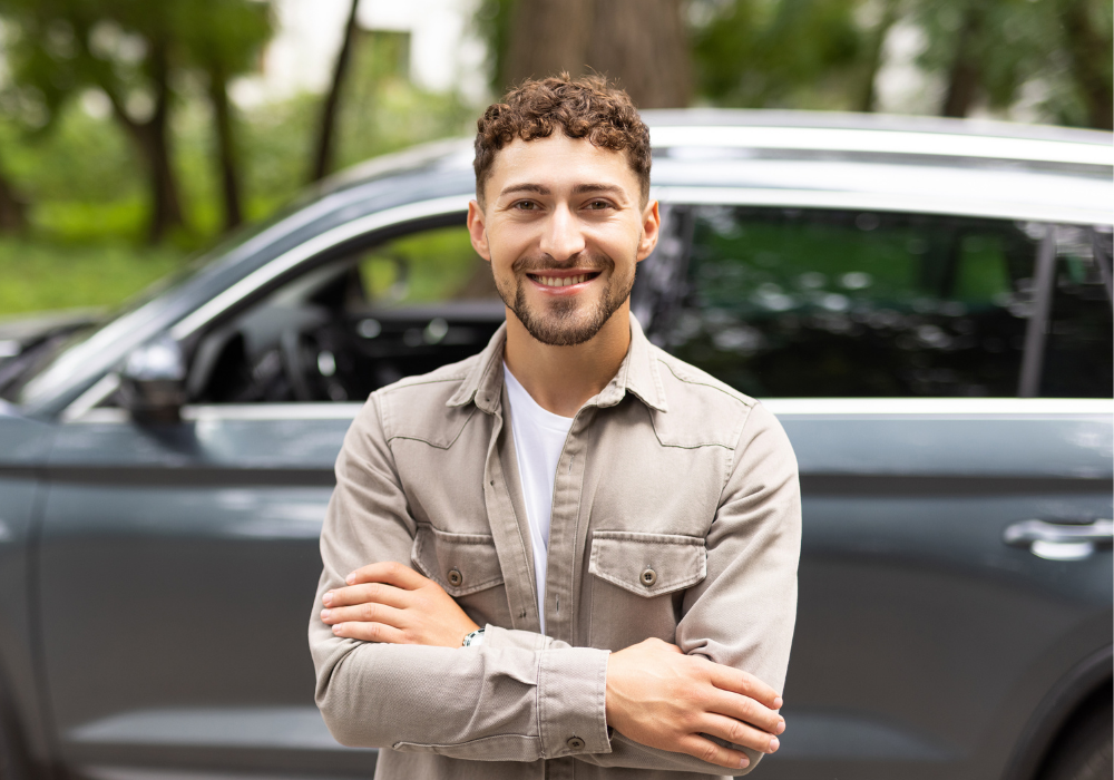 a man standing in front of a car