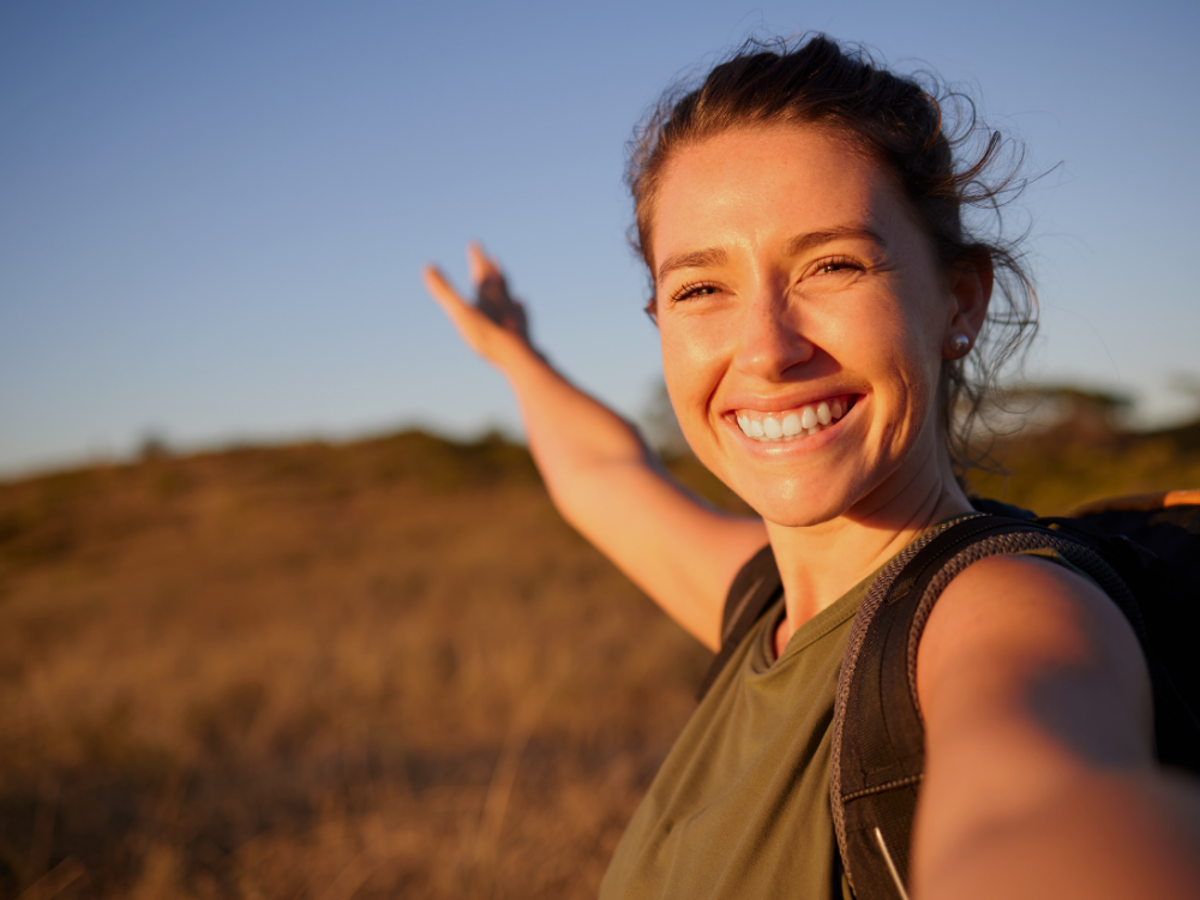 a woman with her arms out in the air