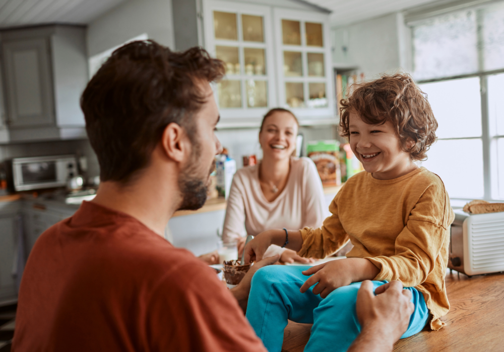 a man and woman sitting at a table with a child